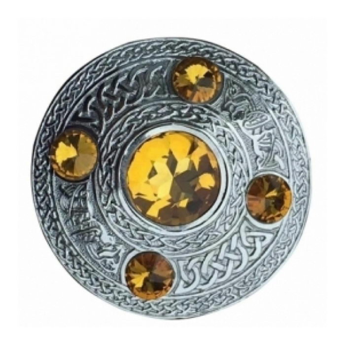 A Plaid Brooch Featuring An Embossed Celtic Design With Yellow Stone